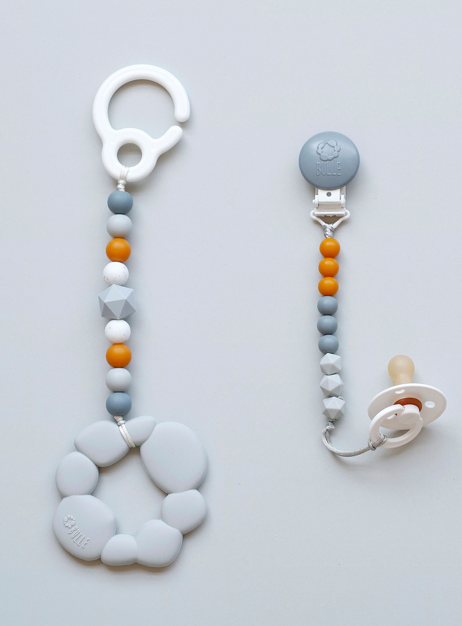 Two pacifier clips with a beaded silicone rope