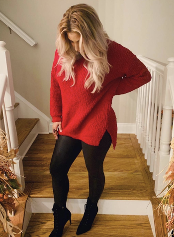 reviewer wearing the red sweater with side slit 
