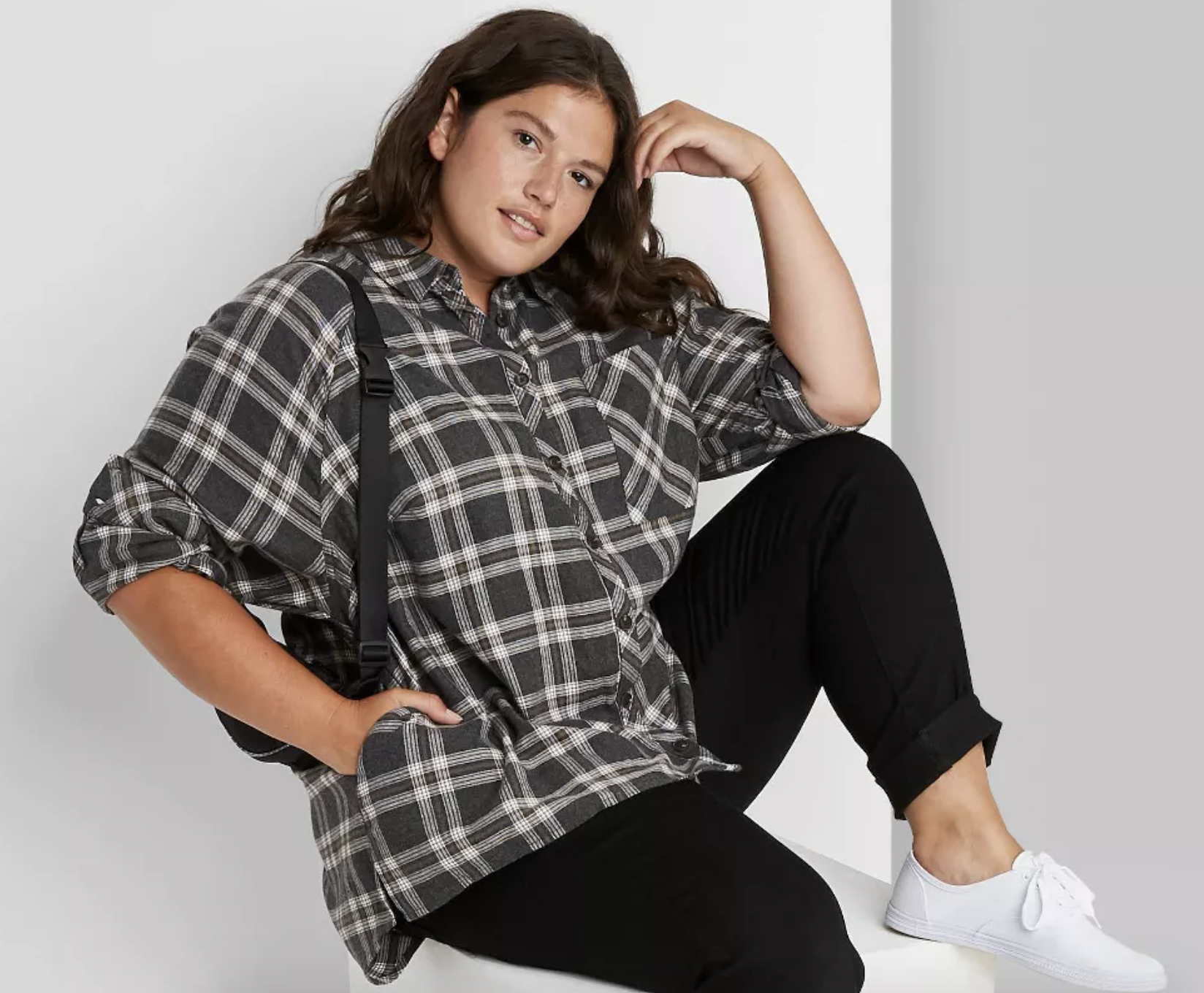 model wearing gray and white plaid shirt