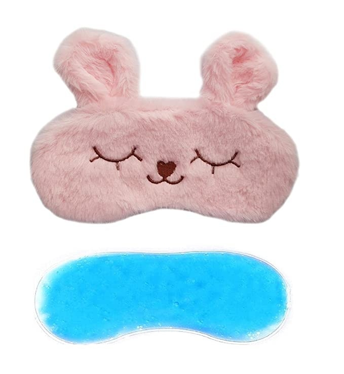 Pink fuzzy sleeping eye mask with bunny ears.