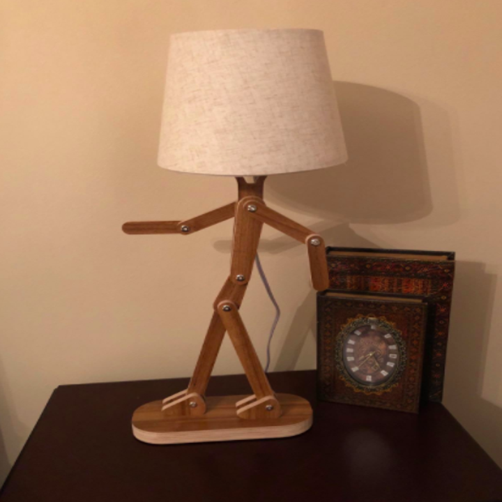 Reviewer shows same cute lamp adjusted in a dancing position on their desk