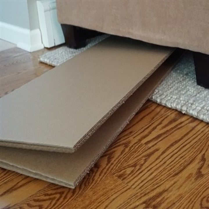 The room divider collapsed to slide under a couch