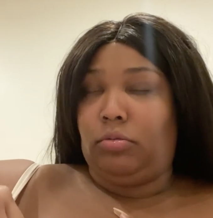 Lizzo trying to remove her nipple pasties is the most painful video