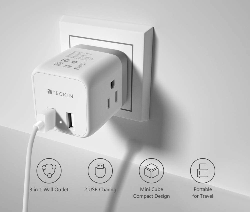 An outlet splitter plugged into a wall with various charging options