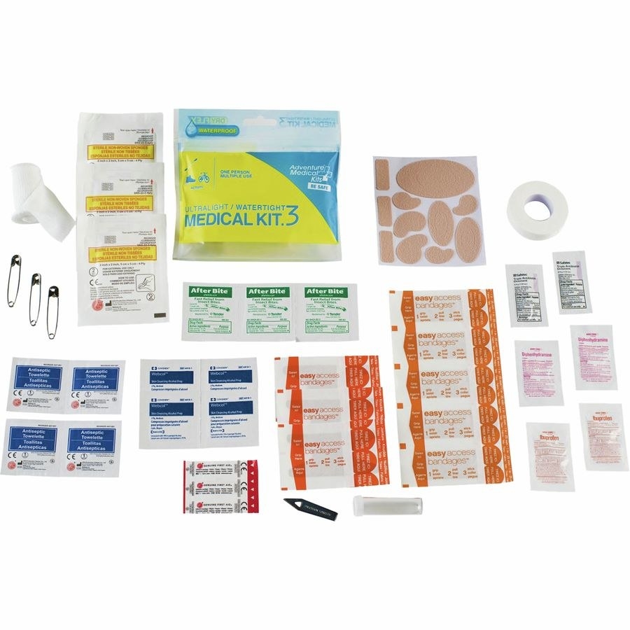 the medkit with the bandages, safety pins, antiseptic pads, and other items splayed out 