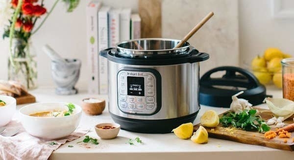 The Instant Pot on a counter surrounded by various ingredients 