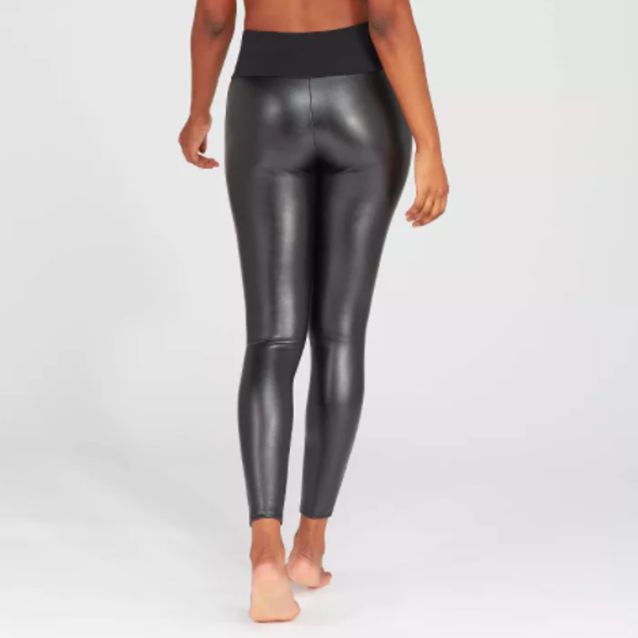 model wearing faux leather leggings shown from the back
