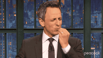 Gif of Seth Meyers making a chefs kiss gesture