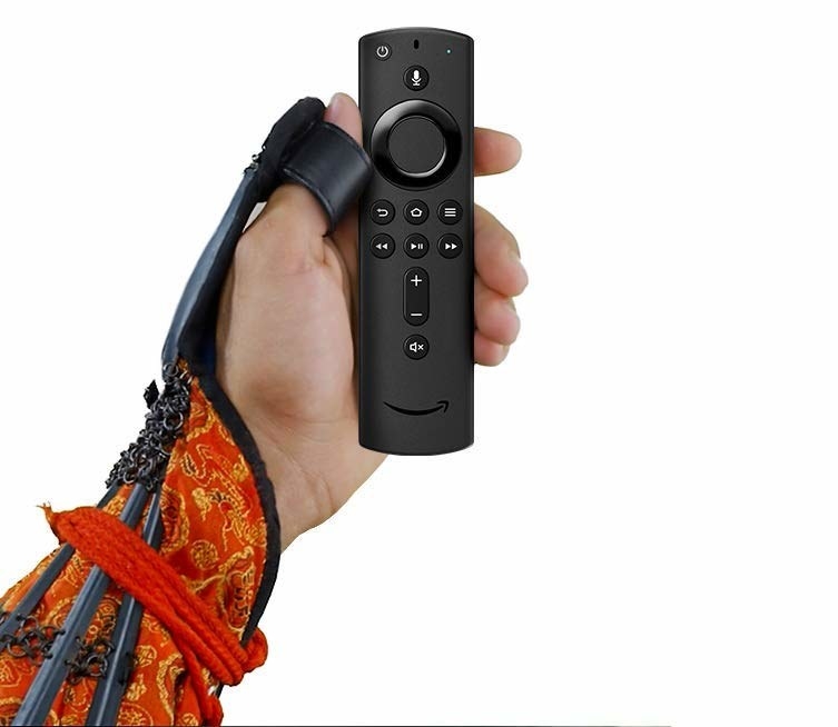 A hand holding the remote