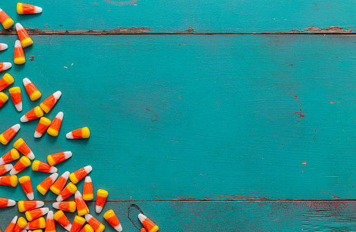 Candy corn across brightly-colored wood