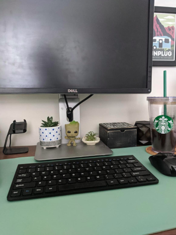 Reviewer uses same style laptop desk in a blue color for their black monitor and keyboard
