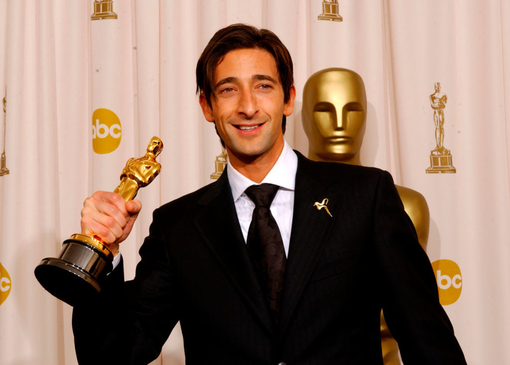 Adrian holding up his Oscar