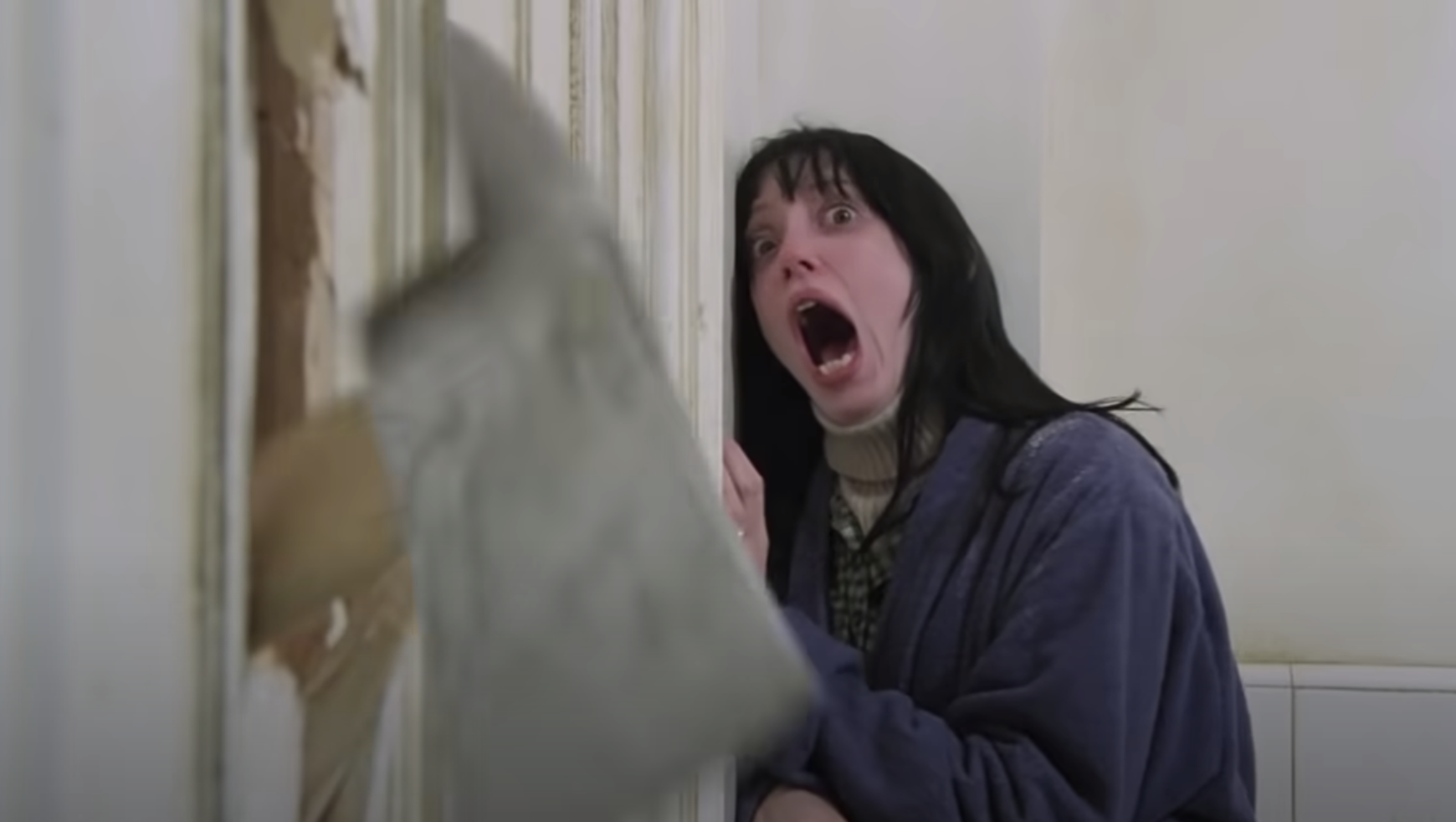 Shelley screaming as Jack uses an axe to break down the door of the bathroom she is in in The Shining