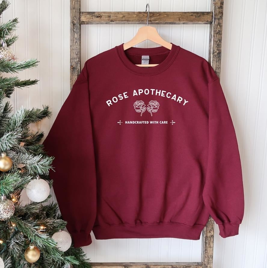 The sweater hung up beside a Christmas tree