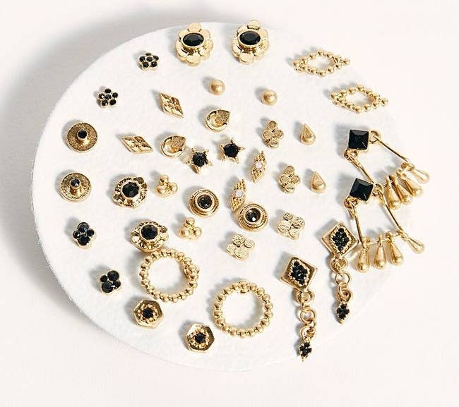 The set of gold tone and black earrings in a variety of shapes and sizes