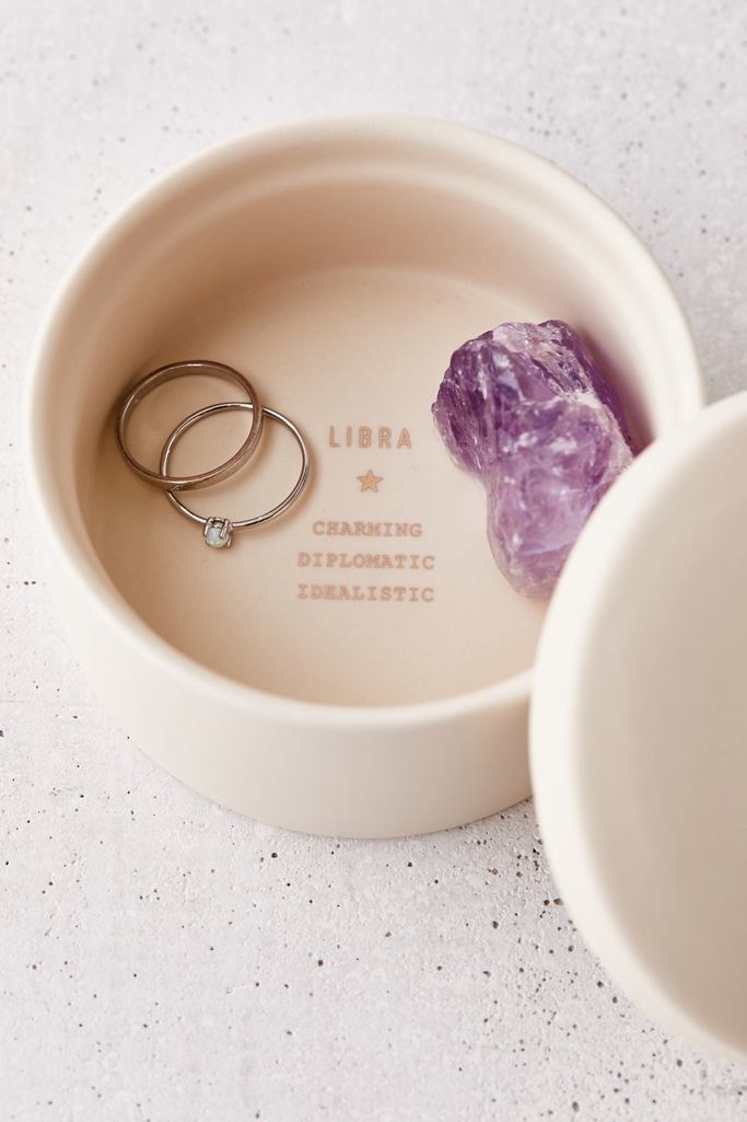 The cream-colored dish with lid, and inside is &quot;Libra charming, diplomatic, idealistic&quot;