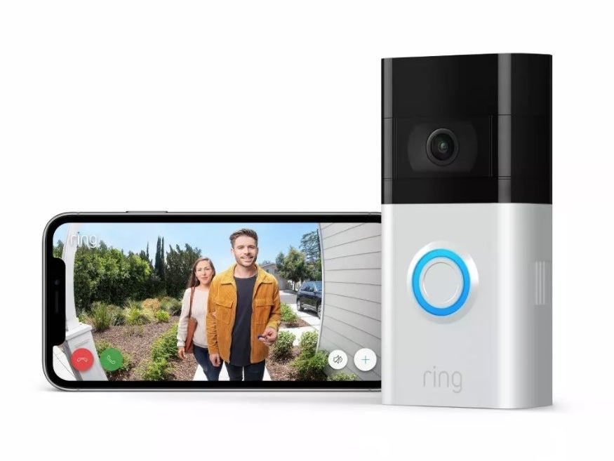 A Ring doorbell next to a phone showing the front door view 