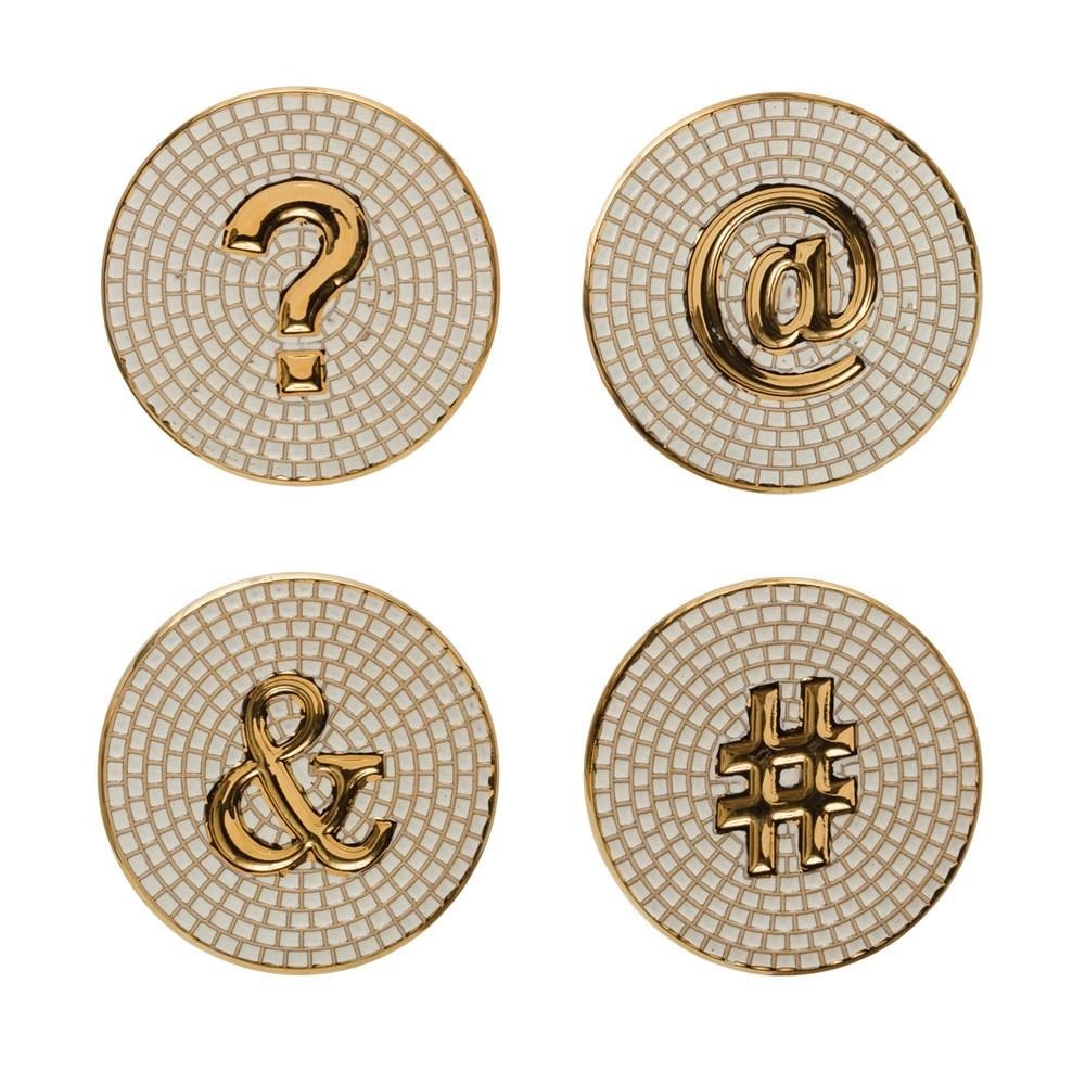 The coasters that look like small white tile mosaics, with a question mark, at-sign, ampersand, and hashtag in the middle of each