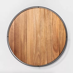 A brown wooden lazy susan with metal edges