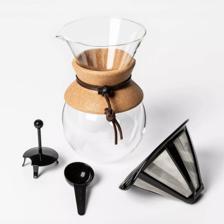 A glass pour over coffee maker with filter and scoop