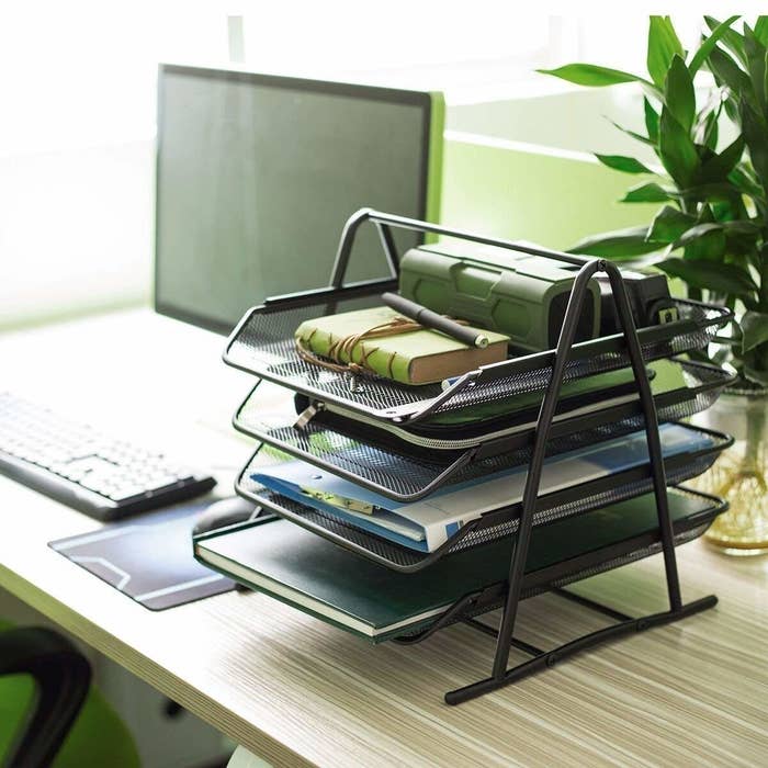 A four-tier mesh organiser pictured on a desk.