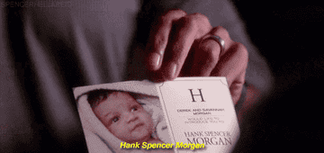 Morgan presenting Reid with Hank&#x27;s baby announcement. 