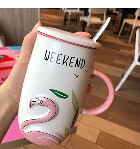 A white and pink mug with an embossed flamingo and the text &#x27;weekend&#x27; written on it.