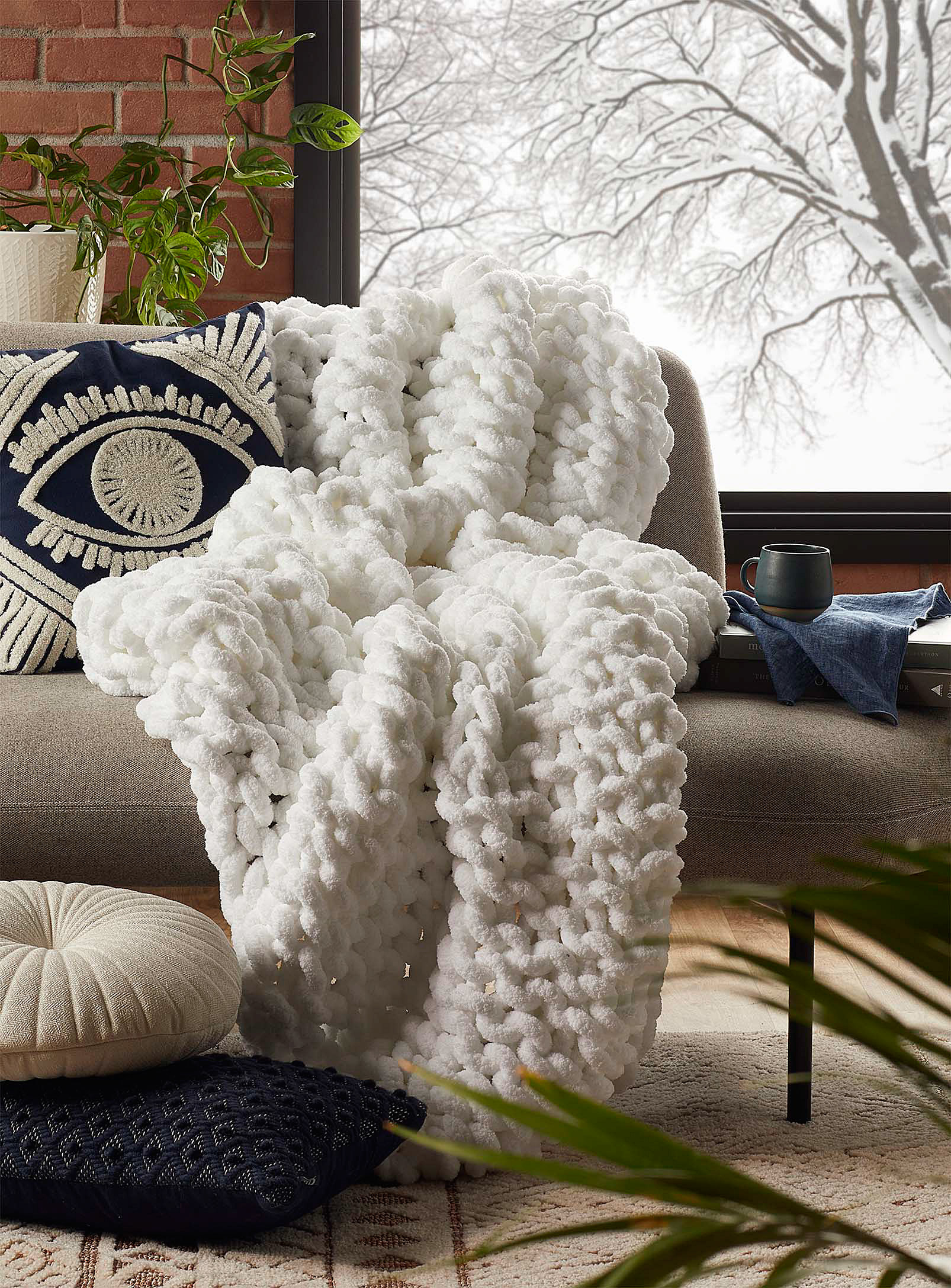 A chunky knit blanket on a chair