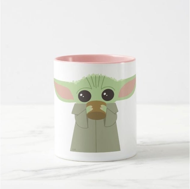 White mug with an illustration of Baby Yoda drinking out of a coffee cup on it