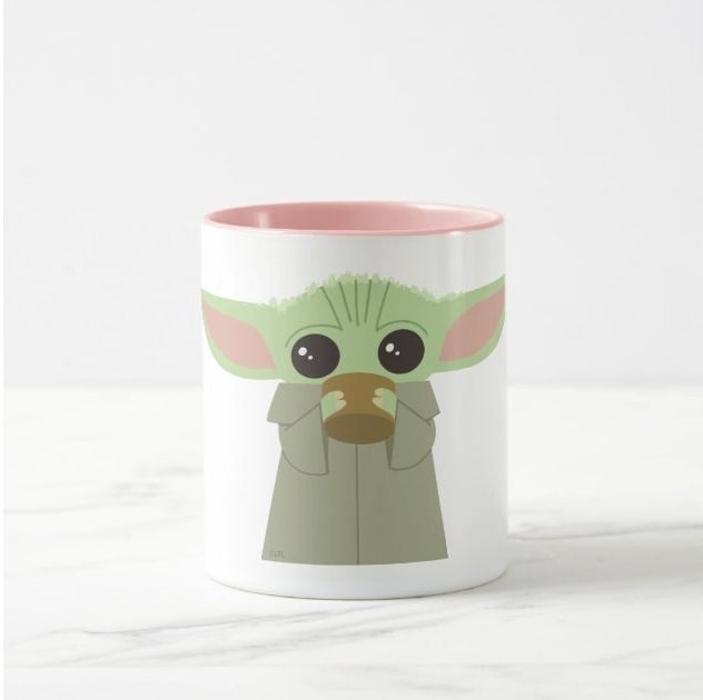 White mug with an illustration of Baby Yoda drinking out of a coffee cup on it