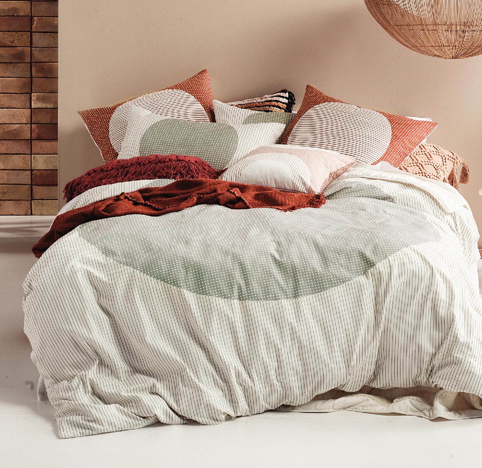 A duvet on a bed covered with pillows