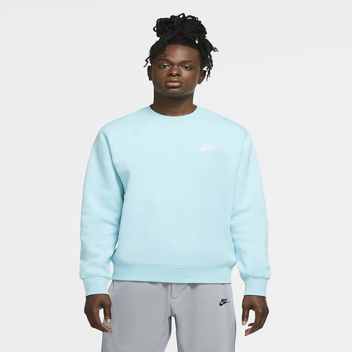 A different model wearing a crewneck sweatshirt in bright blue