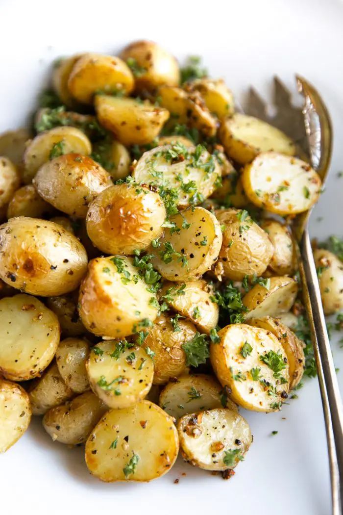 Roasted halved potatoes tossed with herbs.
