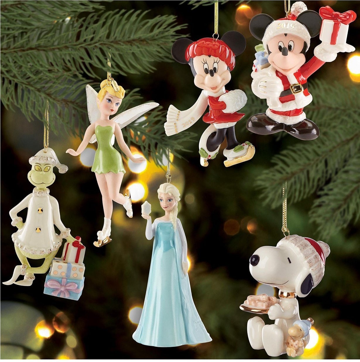 Elsa, Tinkerbell, The Grinch, Snoopy, and Mickey and Minnie ornaments on a tree 