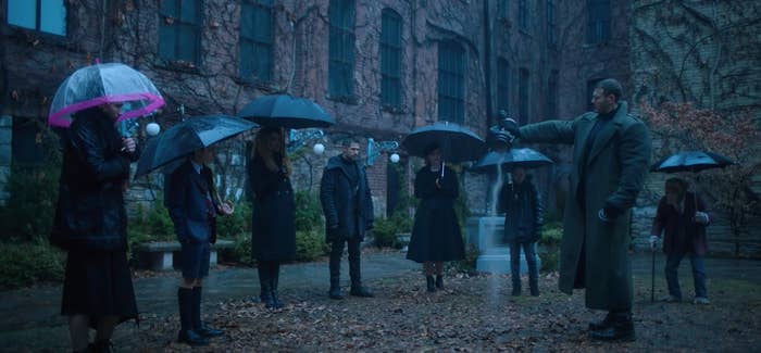 The Hargreeves stand outside in the rain as they pour Reginald&#x27;s ashes on the ground 