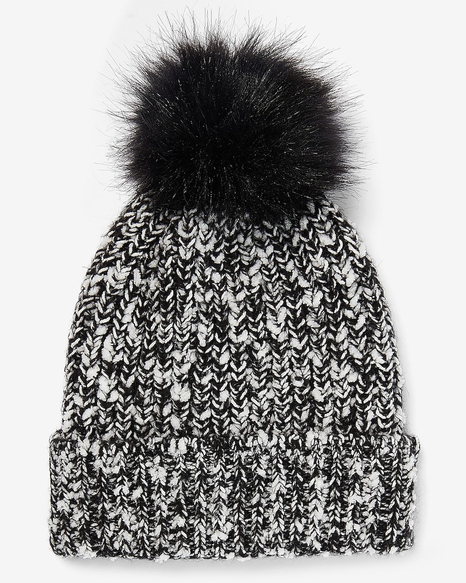 a black and white knit hat with a black pom pom