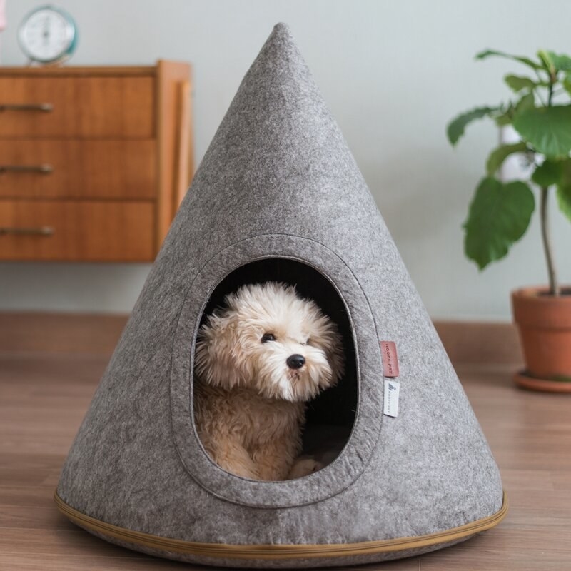 Gray hooded pet cave with tan zipper and white and red tags