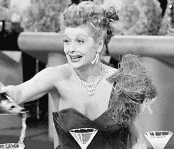 Lucille Ball excitedly throwing champagne everywhere