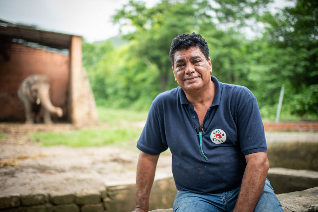 Image of Kaavan the elephant at Marghazar Zoo in Islamabad, Pakistan with his veterinarian Dr. Amir Khalil smiling at the camera 