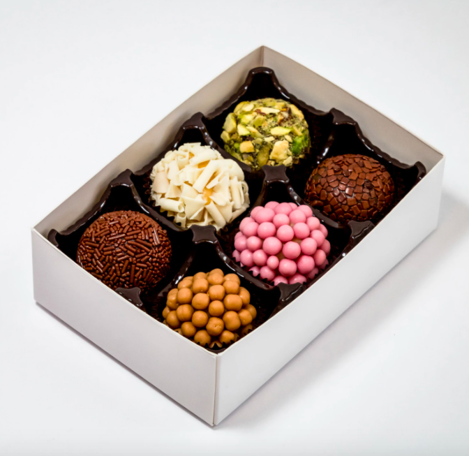 An open box of six different hand-rolled chocolates