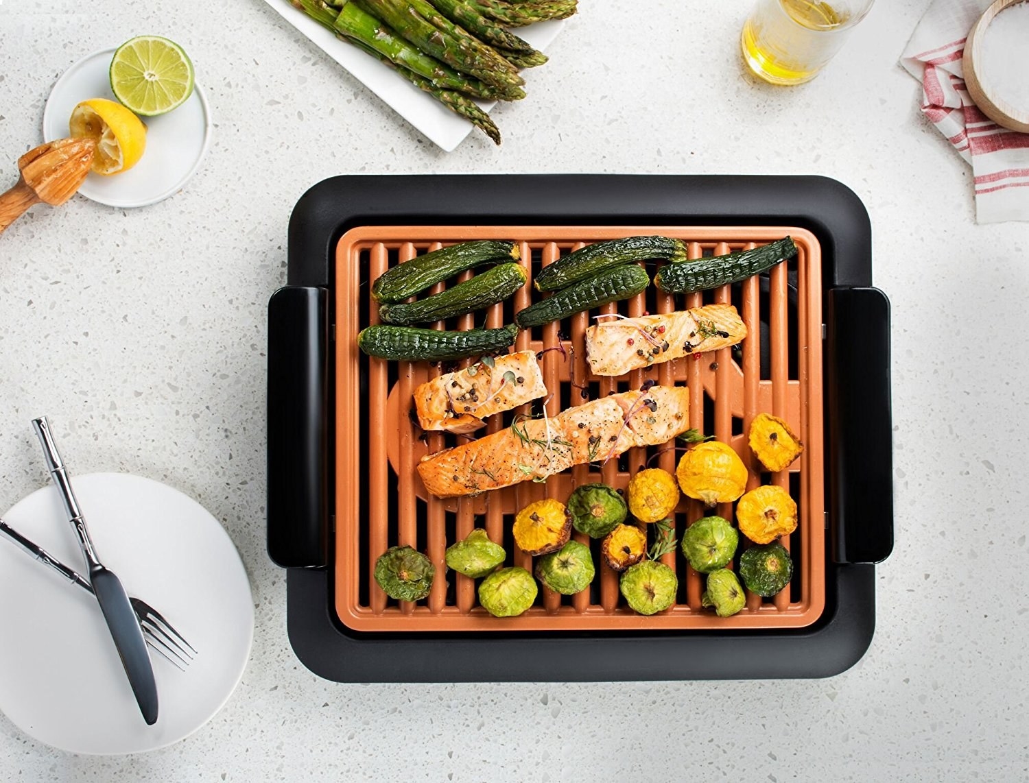 salmon and vegetables cooking on a electric smokeless grill 