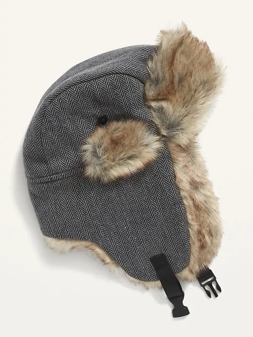 A grey trapper hat with light brown faux-fur on the inside