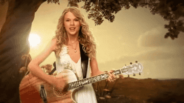 Taylor playing guitar in front of a tree and field
