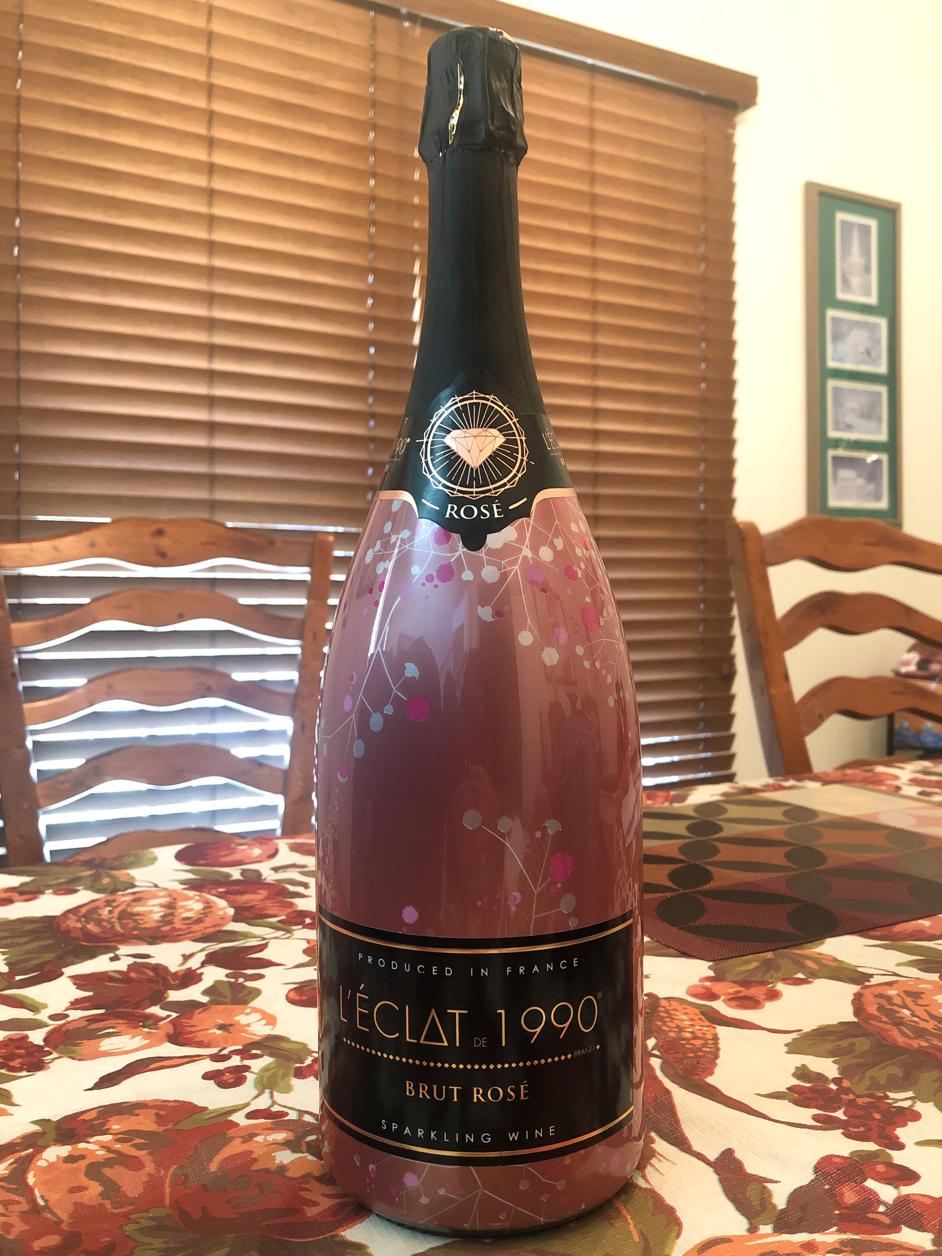 A very large bottle of sparkling rosé on a table
