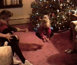 a home video of Taylor&#x27;s mom pushing her on a swing in the living room in front of a Christmas tree