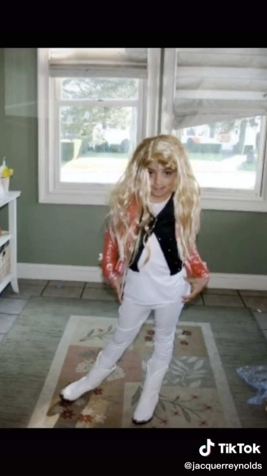 @jacquerreynolds nailing a pose in her wig, jacket, vest, and cowboy boots