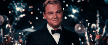 Leo DiCaprio as Jay Gatsby raising a glass