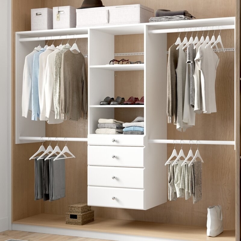 White closet system with white rods and silver knobs