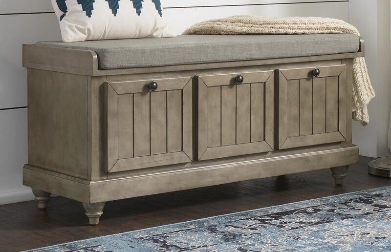 Antique gray storage bench with gray cushion and dark gray knobs