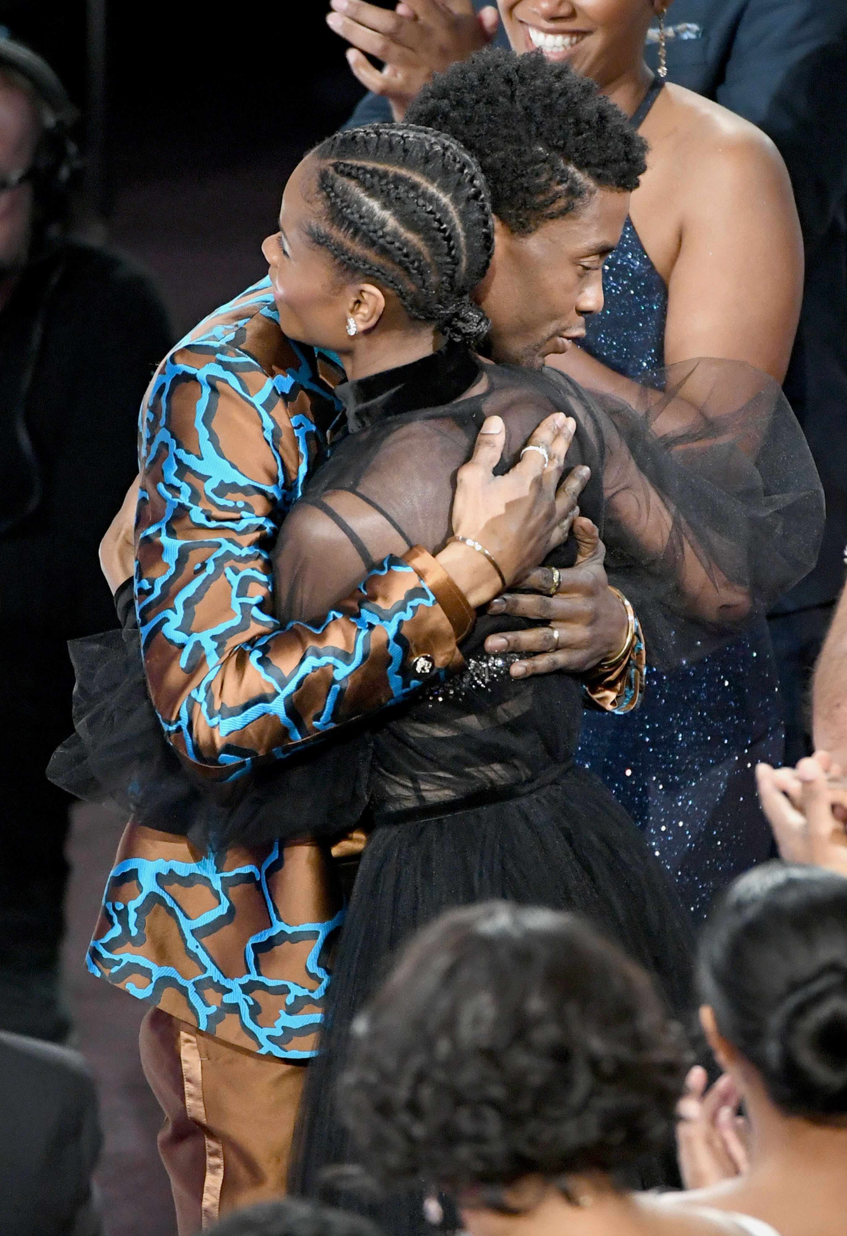 Chadwick Boseman and Letitia Wright hugging each other at the 50th NAACP Image Awards